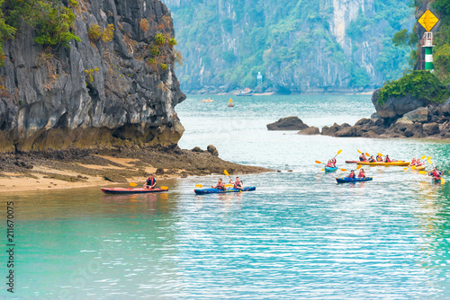 HALONG, VIETNAM - DECEMBER 16, 2016: Group of people in kayaks in the bay. Copy space for text.