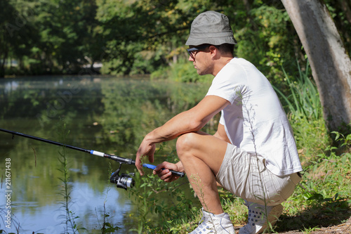 fisher man fishing at lakeside