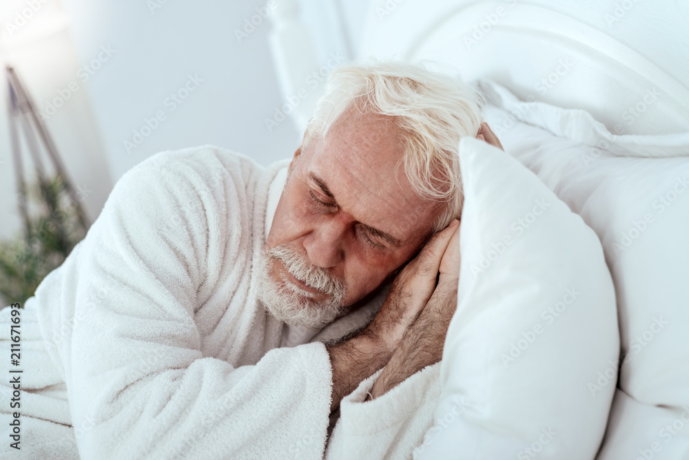 Sweet dreams. Relaxed senior man lying in bed and dreaming Sweet dreams. Relaxed senior man lying in bed and dreaming