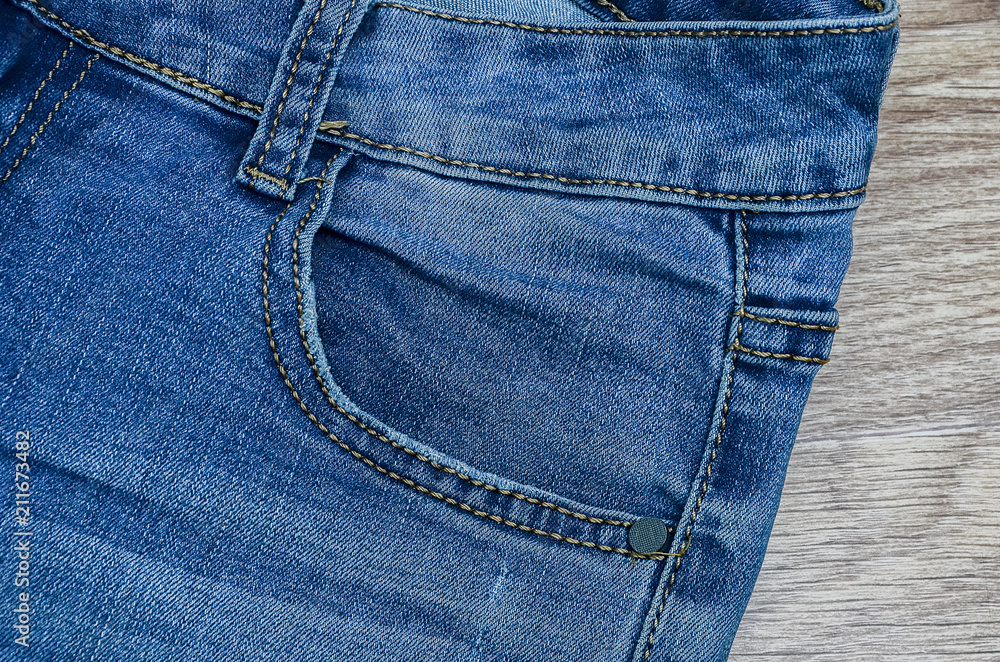 jeans on the background, blue jeans lie on a wooden background, jeans on the background, blue jeans lie on a wooden background,
