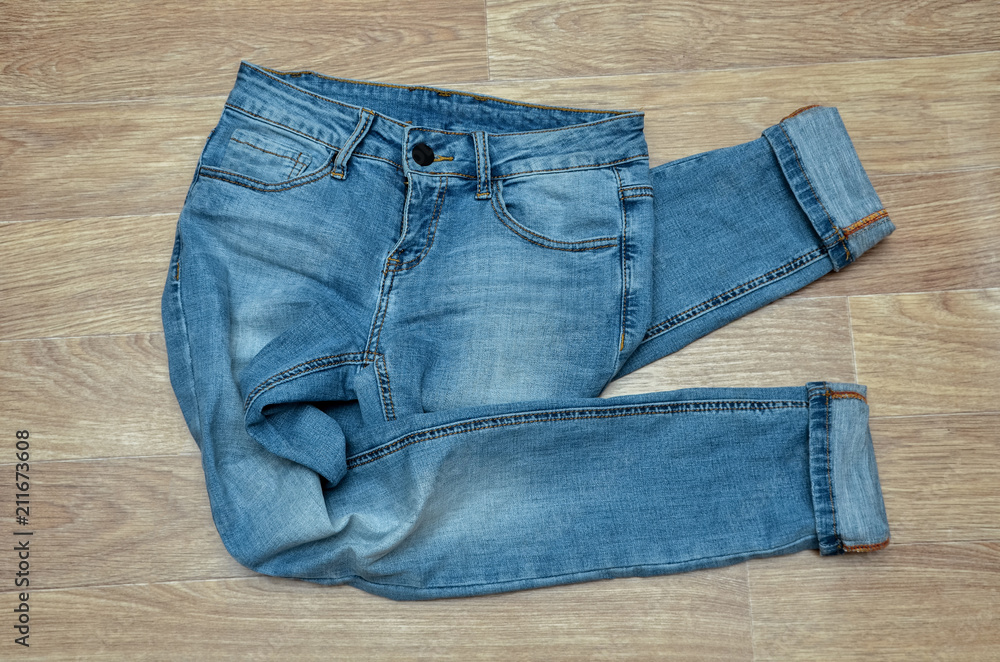 jeans on the background, blue jeans lie on a wooden background, jeans on the background, blue jeans lie on a wooden background,