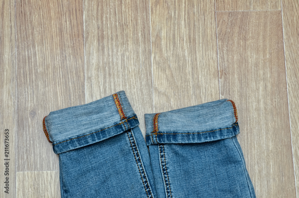 jeans on the background, blue jeans lie on a wooden background, jeans on the background, blue jeans lie on a wooden background,