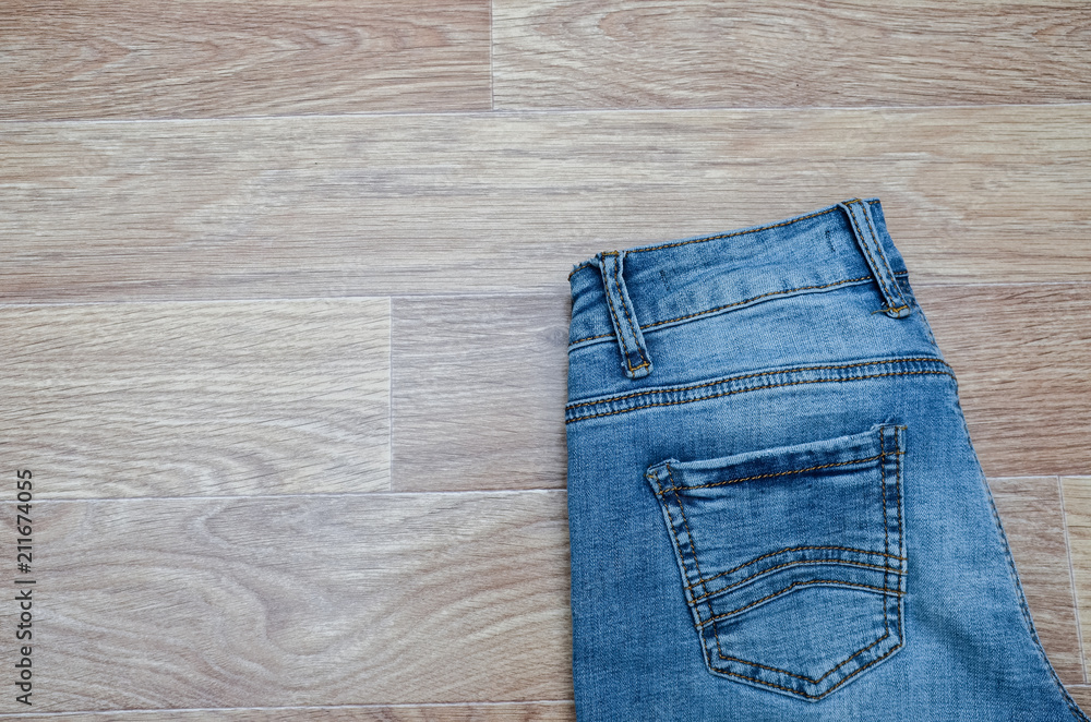 jeans on the background, blue jeans lie on a wooden background, jeans on the background, blue jeans lie on a wooden background,