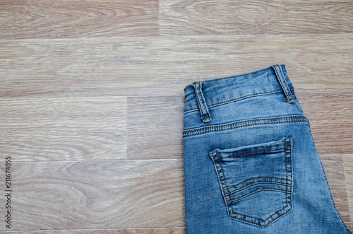 jeans on the background, blue jeans lie on a wooden background,