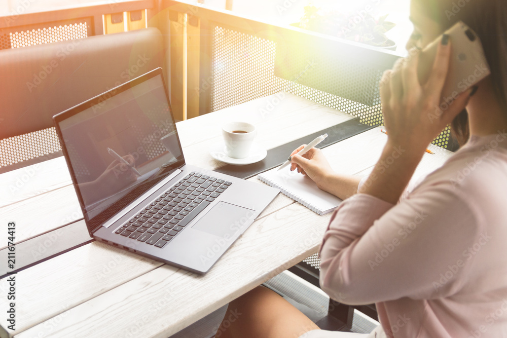 Businesswoman talking on phone in office or in a cafe Businesswoman talking on phone in office or in a cafe