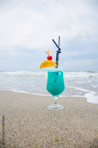 Blue coctail in the glass on the sea background
