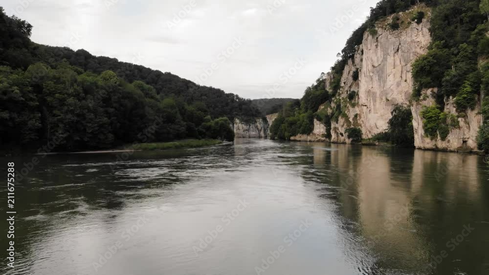 A slow left panning drone shot of a beautiful bend in the Danube River near Kelheim in Germany. A slow left panning drone shot of a beautiful bend in the Danube River near Kelheim in Germany.