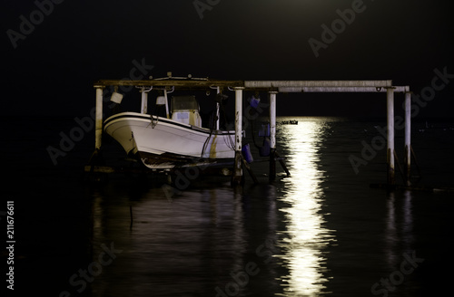 Reflection of Supermoon and a boat at Asker coast of Bahrain on 14 November 2016