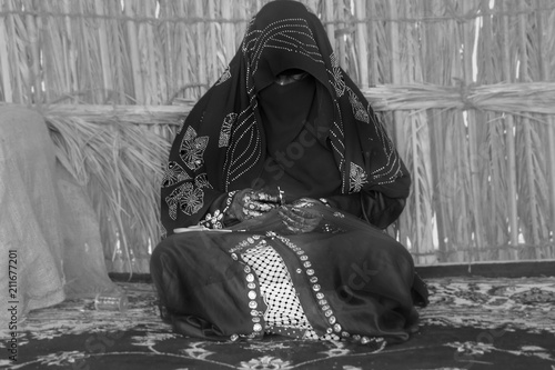 Emirati woman is in the process of weaving traditional basket