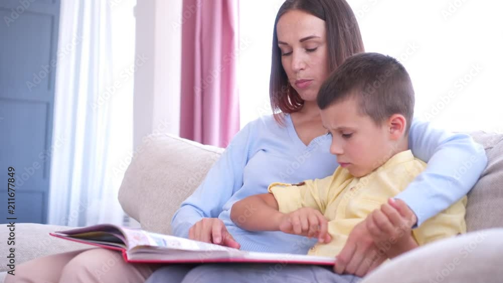 Young mother and son reading a storybook Young mother and son reading a storybook
