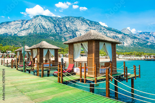 Fototapeta Naklejka Na Ścianę i Meble -  Wooden beach pavilions on the shore of a sandy beach