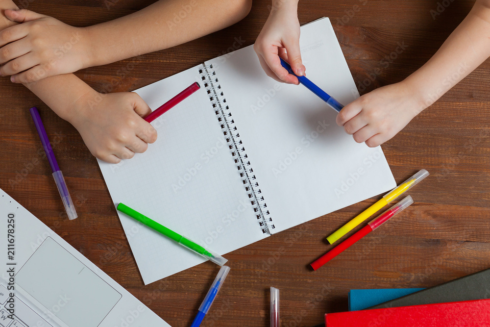 Children do homework at the table. Kids draws on a blank sheet of paper. Preschoolers do homework together. Boy and girl writing a letter. Children do homework at the table. Kids draws on a blank sheet of paper. Preschoolers do homework together. Boy and girl writing a letter.