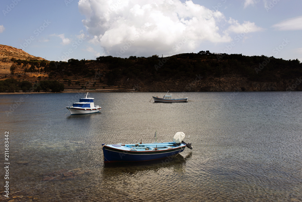Three fishing boats in the sea in the island of Patmos, Greece in summer time