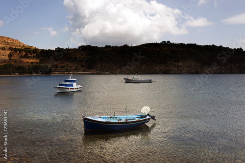 Fototapeta Naklejka Na Ścianę i Meble -  Three fishing boats in the sea in the island of Patmos, Greece in summer time