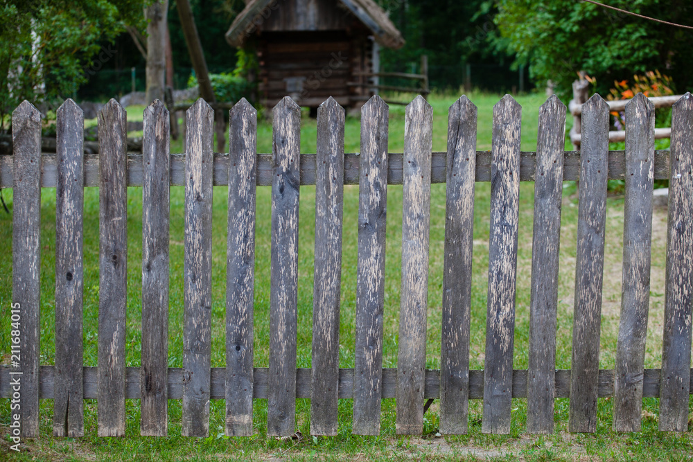 House behind a wooden fence in a Polish village near Bialystok
