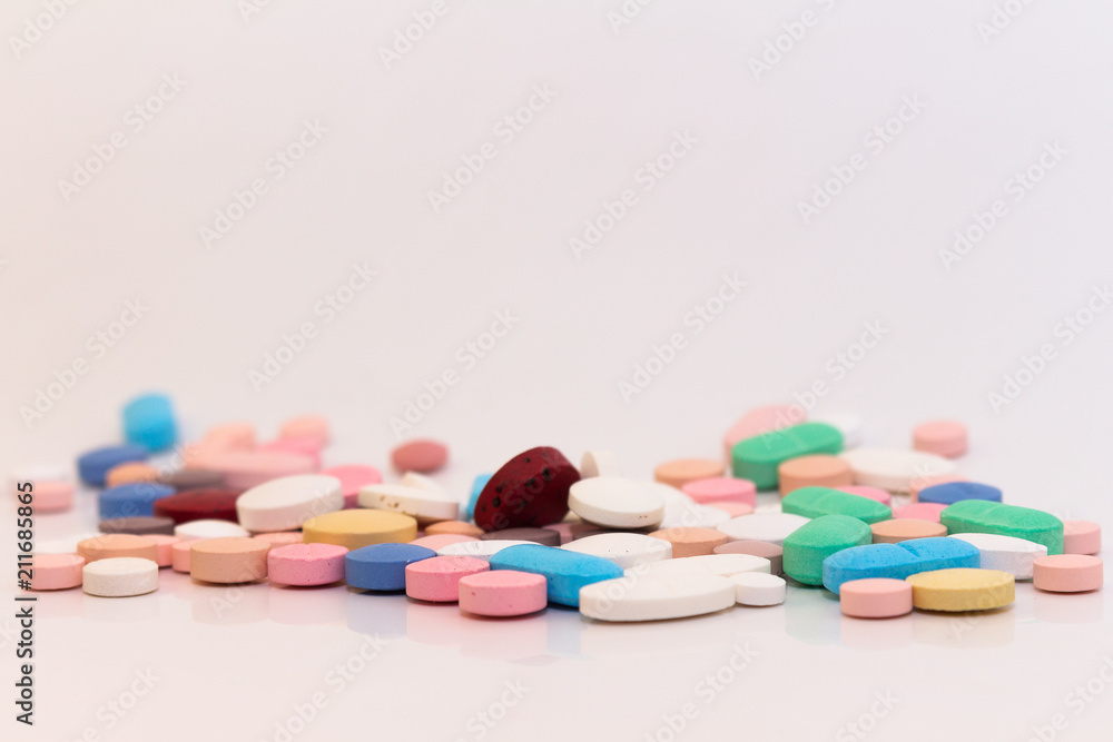Numerous medicines Medications in the form of tablets. Colored pills on a white background. Numerous medicines Medications in the form of tablets. Colored pills on a white background.