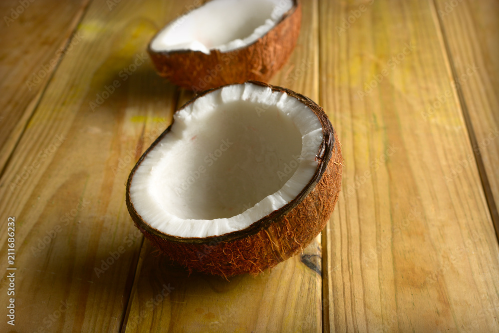 open coconut on wooden table open coconut on wooden table