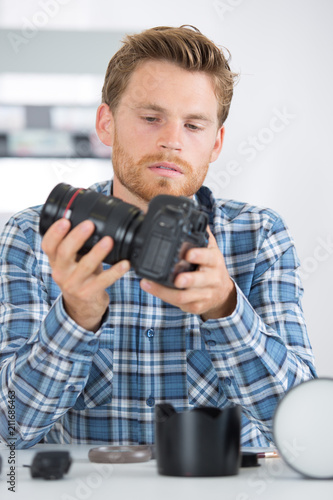 technician fitting camera lens to body © auremar