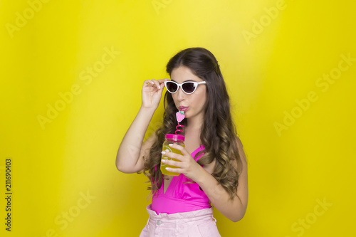  girl with long hair with glasses drinking juice