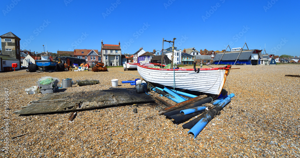 Aldeburgh beach with boats and old and new Lifeboat stations with tower.