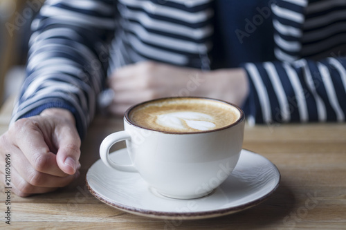 Girl having a break with cup of coffee, close up, soft focus, vintage filter.
