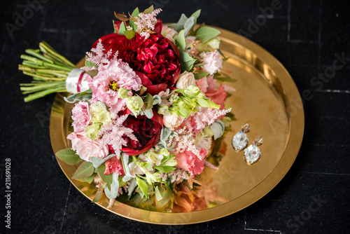 Beautiful wedding bouquet at the black background table photo