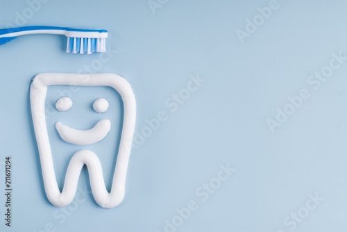 Toothbrush and tooth paste on a blue background
