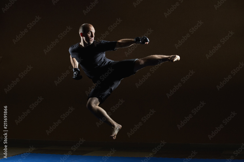 A concentrated athlete beats a kick in a jump