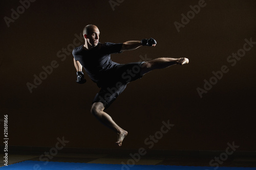 A concentrated athlete beats a kick in a jump