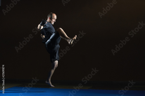 Strong man beats with a kick leg © andreyfire