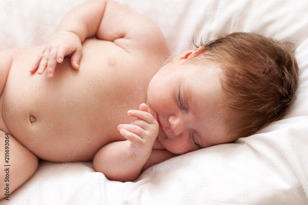 Newborn baby girl sleeping on a summer day at home Newborn baby girl sleeping on a summer day at home