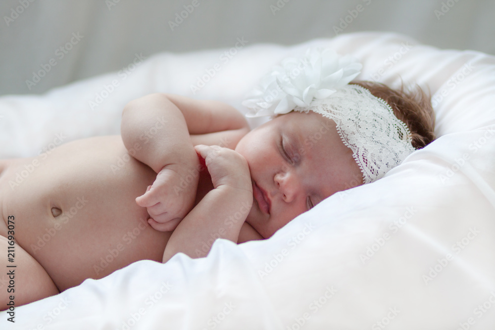 Newborn baby girl sleeping on a summer day at home Newborn baby girl sleeping on a summer day at home
