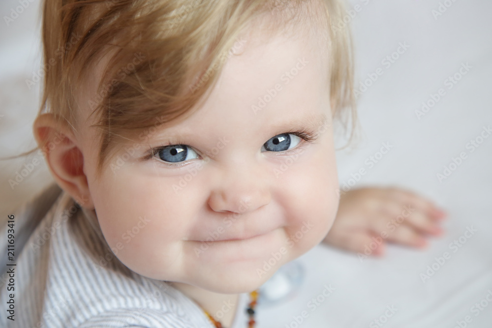 Portrait of adorable blonde baby girl laying on the bed Portrait of adorable blonde baby girl laying on the bed