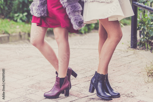Two women presenting shoes outdoor
