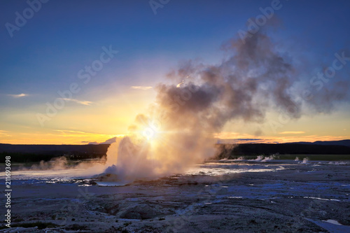 Clepsydra Geyser in the Lower geyser basin at Yellowstone National Park erupts almost continuously and looks spectacular at sunset at this park in Wyoming.