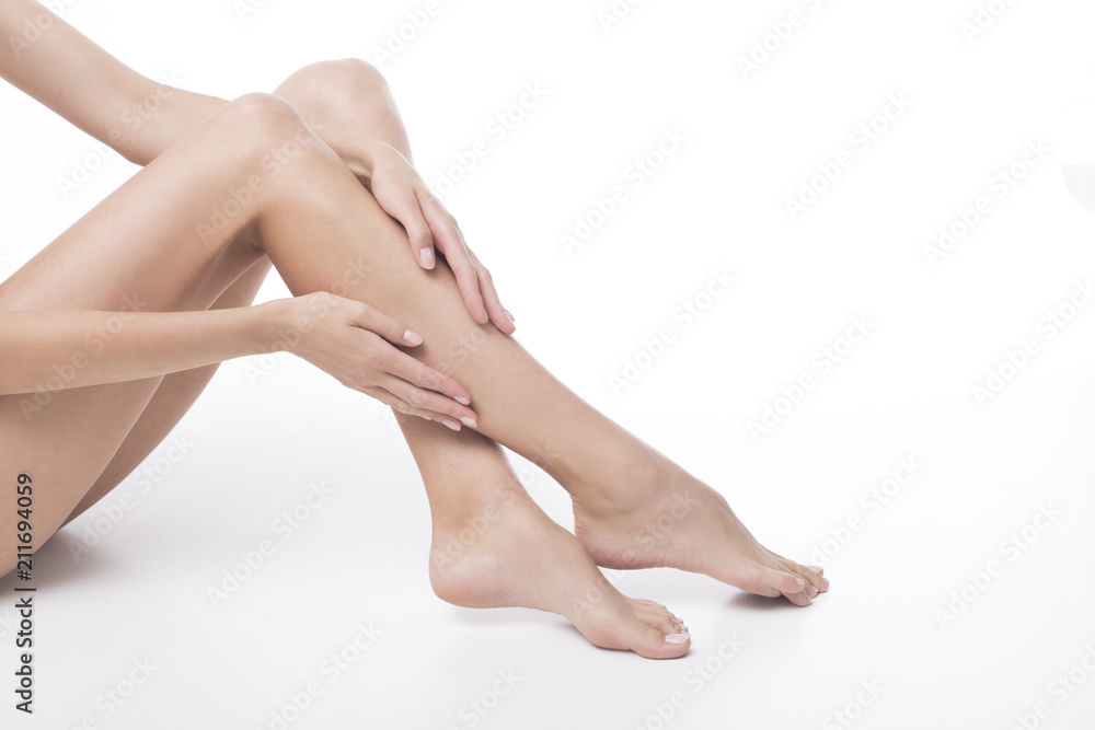 Beautiful legs and hands on white background. Pedicure and manicure time.