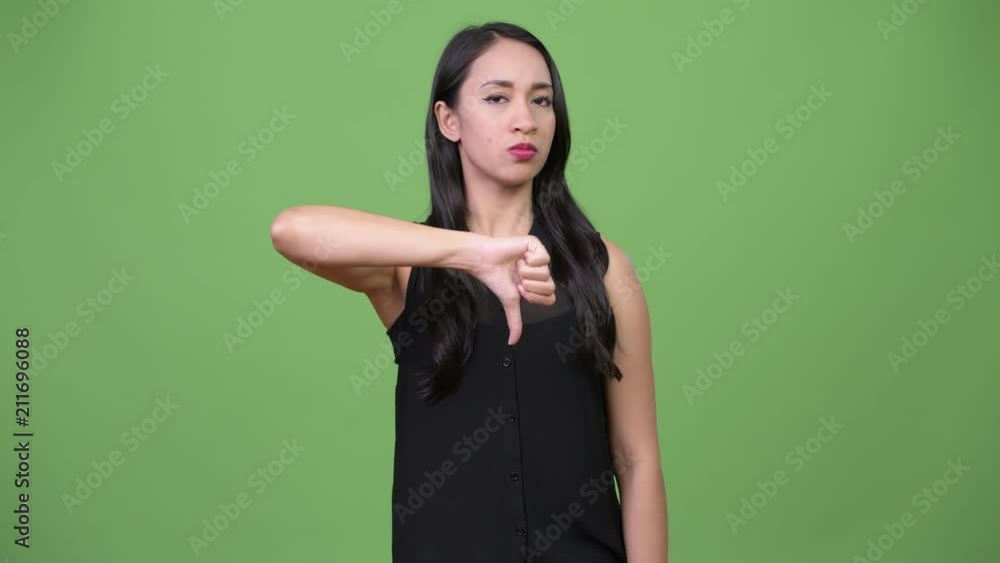 Young beautiful Asian businesswoman giving thumbs down