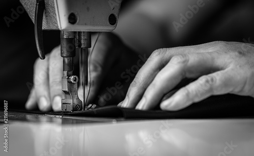 a man at work on a sewing machine. without a face. photo