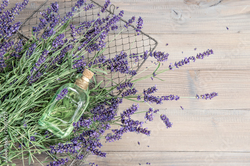 Lavender oil fresh flowers wooden background