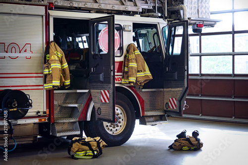Firemen gear on firefighter truck in the fire station photo