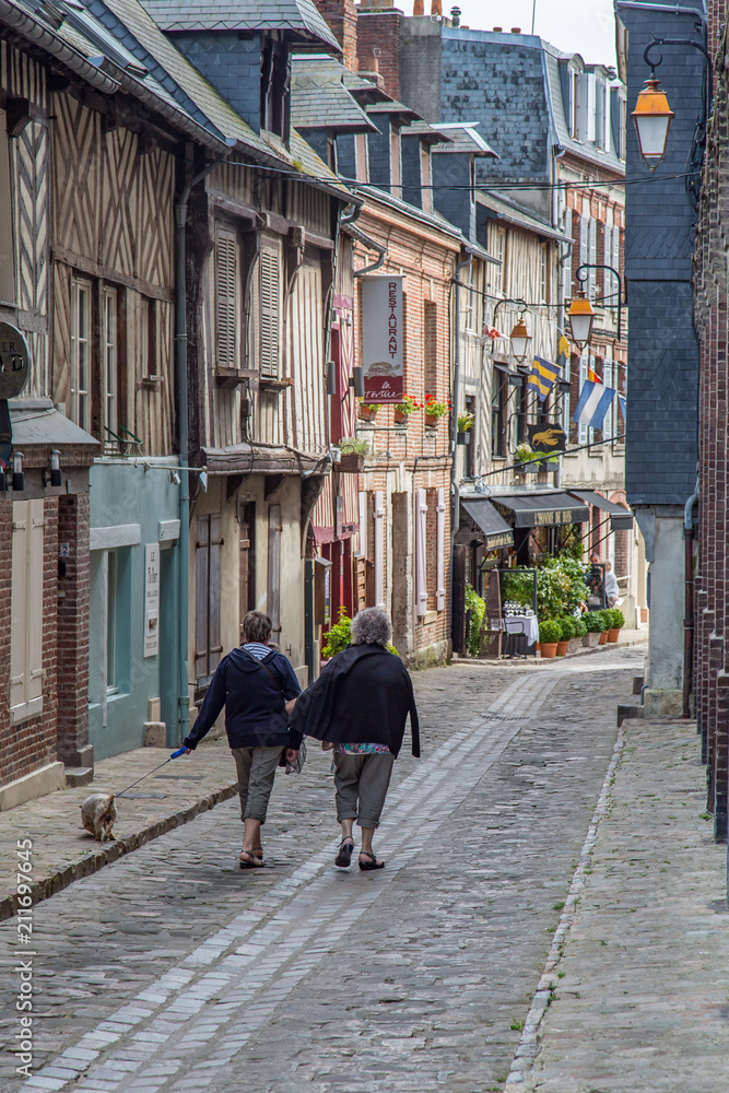 Two Women Walking Down a Narrow Lane in the Ancient Historic Port City of Honfleur, France