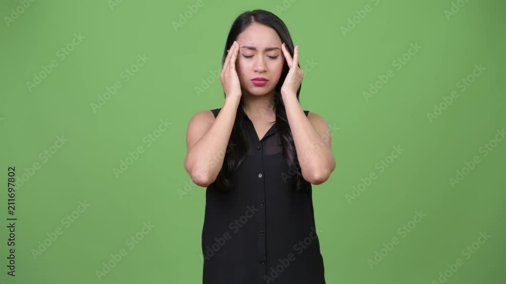 Young beautiful Asian businesswoman having headache Young beautiful Asian businesswoman having headache