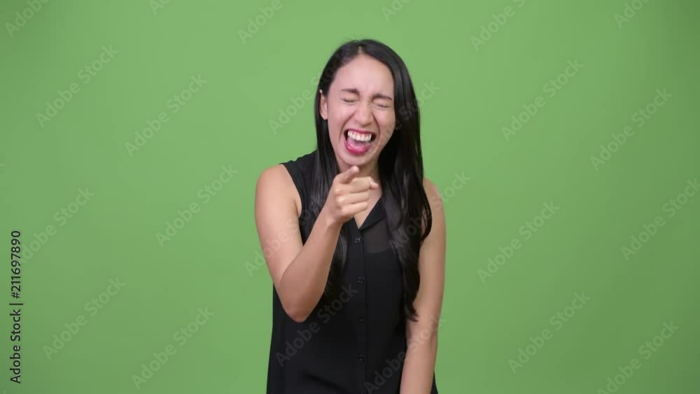 Young beautiful Asian businesswoman laughing Young beautiful Asian businesswoman laughing