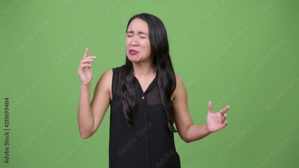 Young beautiful Asian businesswoman looking angry Young beautiful Asian businesswoman looking angry