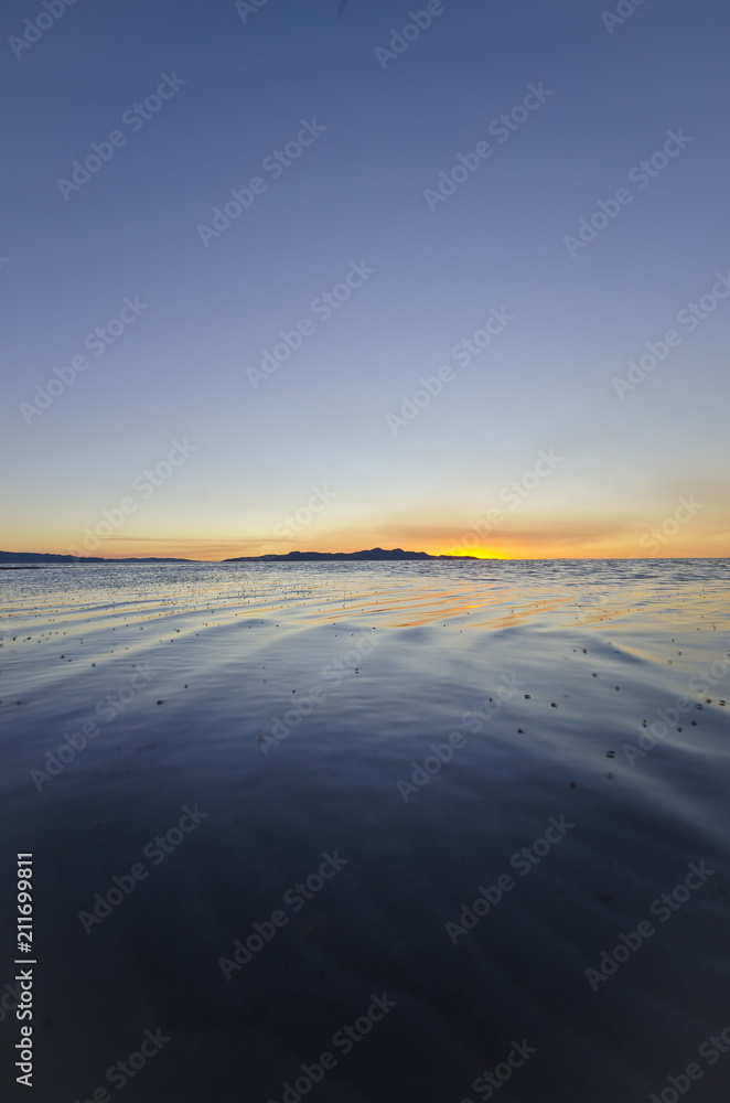 A cool calm blue and orange sunset at the great salt lake in utah. 