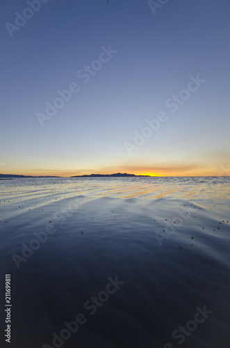 A cool calm blue and orange sunset at the great salt lake in utah. 