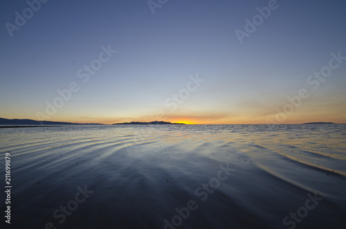 The calm wavy water of the great salt lake evening sunset light. 