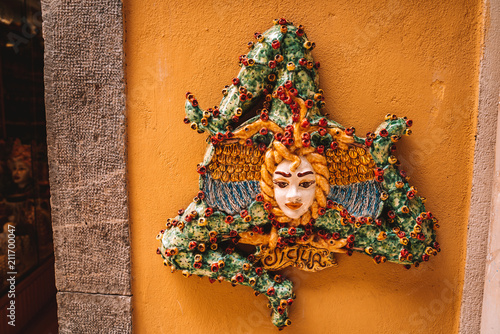 ITALY, SICILY,MEDUSA, 20-06-2018: Ceramic head of Medusa with beautiful face of a young girl. Gorgon medusa is an emblem of Sicily symbolizing the invincibility of the goddess photo