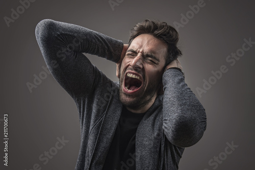 Enraged troubled man screaming in anger, crazy and mental