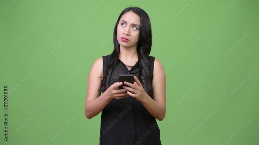 Young beautiful Asian businesswoman using phone Young beautiful Asian businesswoman using phone